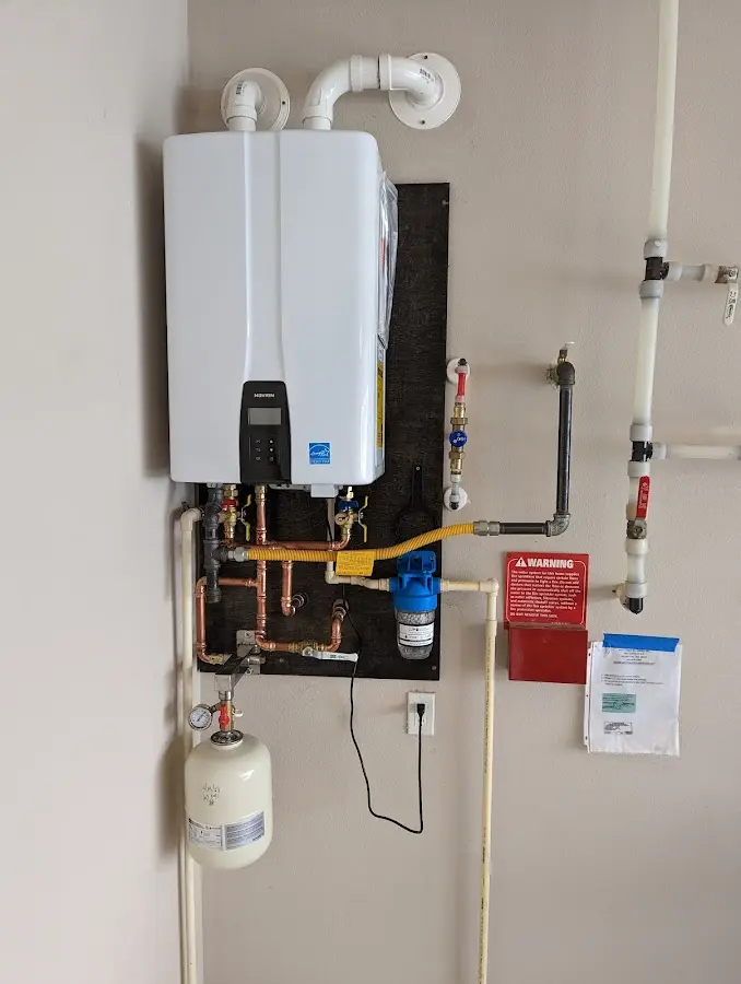 Professional plumber installing copper piping in a Hinton home